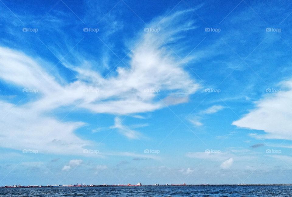 Cloudscape on the sea, abstract "flying horses rule the blue sky" by cirrostratus clouds.