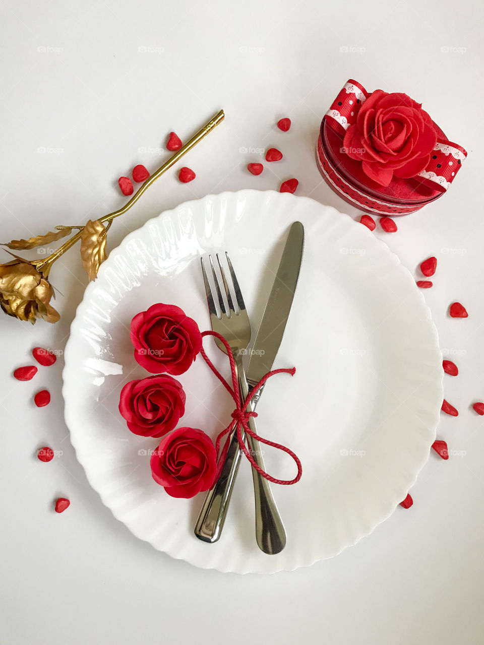 Valentine’s table set up with Red and golden rose and the gift 