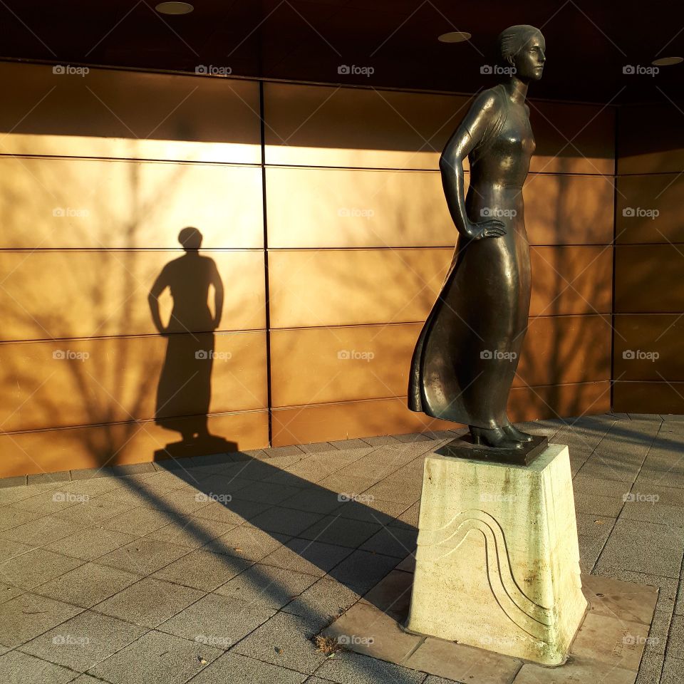Sculpture and its shadow in autumn