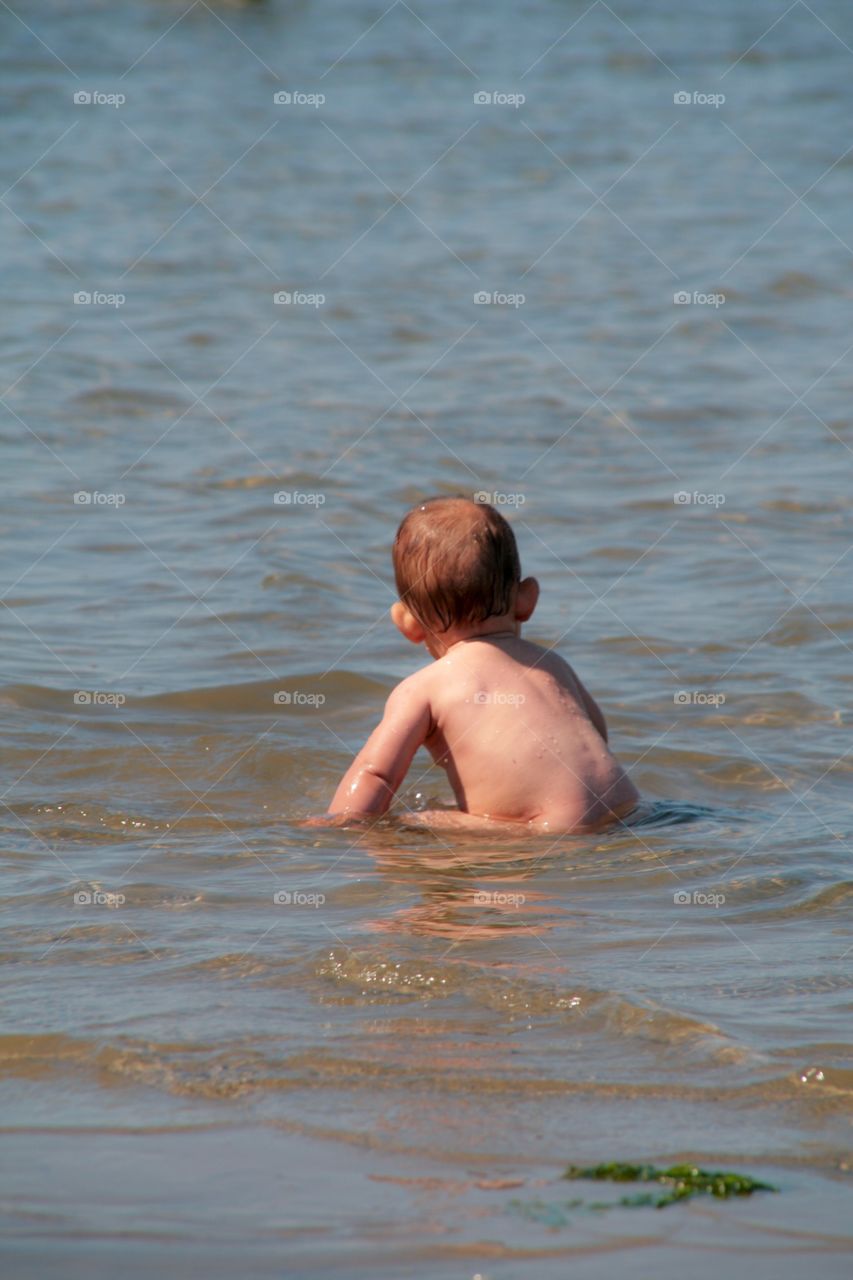 Little girl sitting in the water