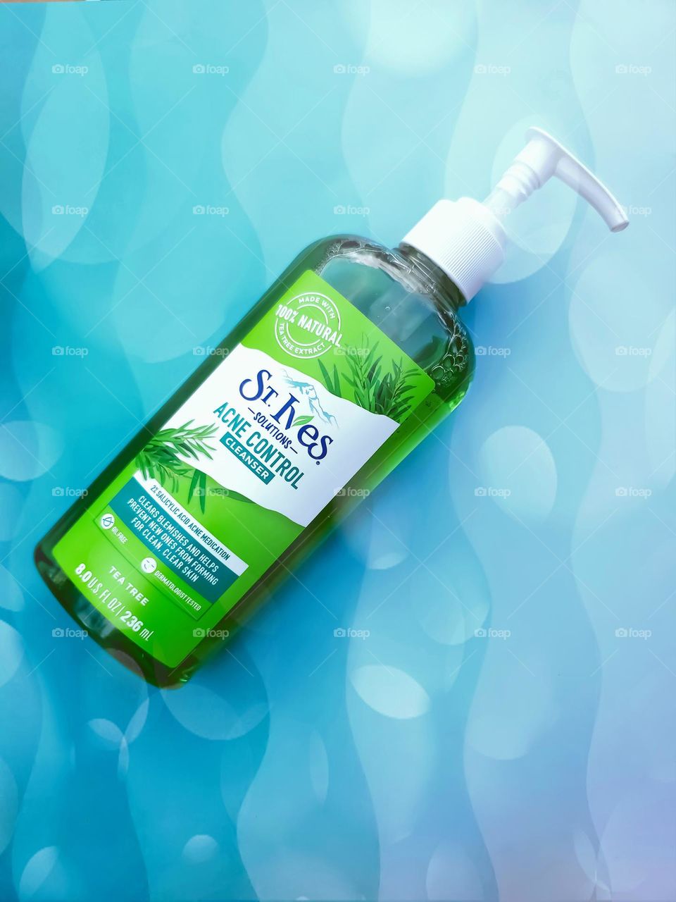 St. Ives Acne control cleanser on a fun summer vibes bubbly wavey aqua colored background.