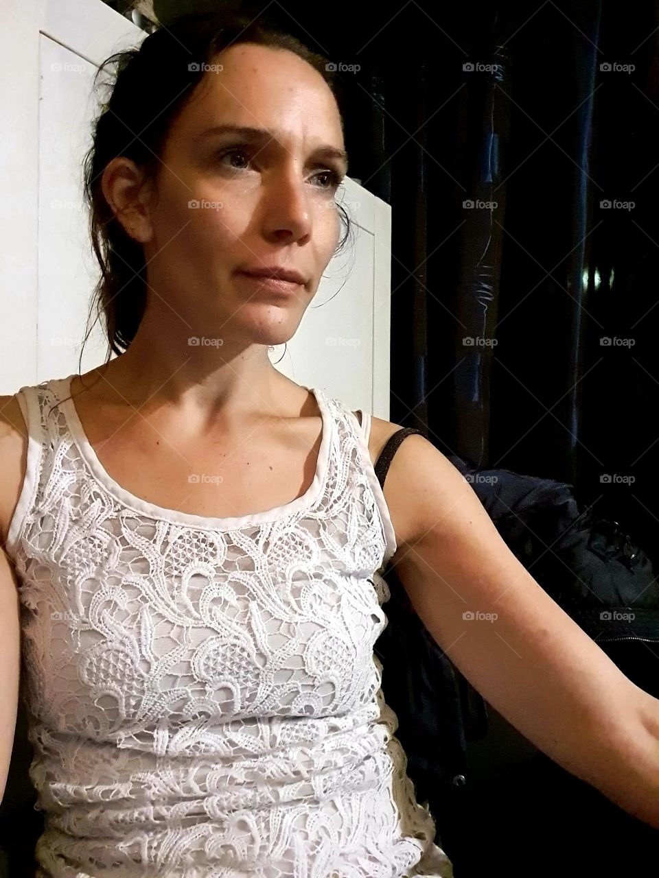 Woman sitting at dining table looking forward