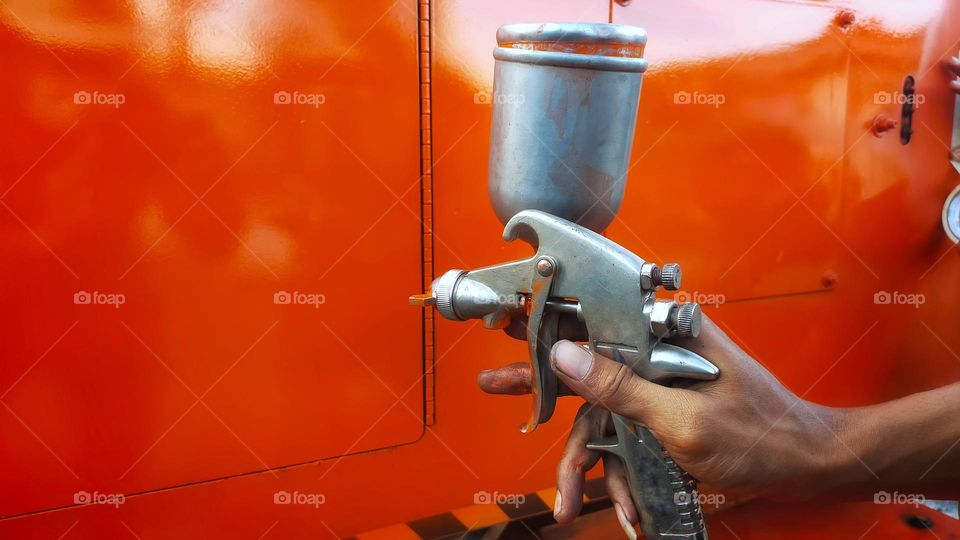 Painting process with a paint gun sprayer.