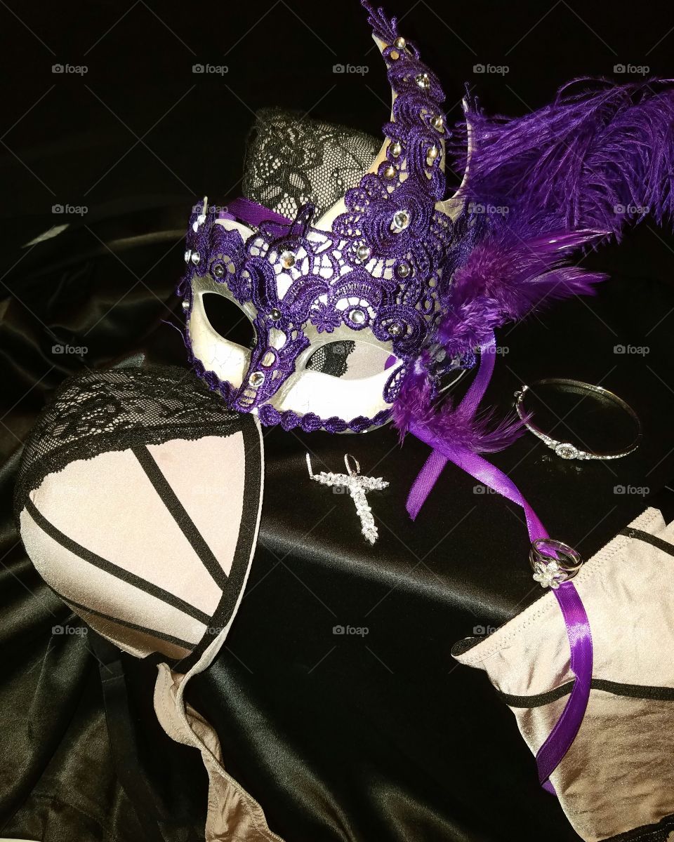 purple laced Mardi Gras mask with purple feather and purple satin ribbons. lingerie mauve  with black trim.  Diamond Jewelry earrings fleur de lis ring and bracelet