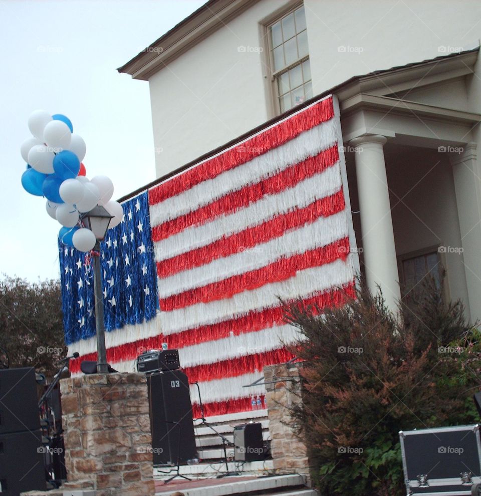 large American Flag streamer decoration at the music performance stage for the 4th of July celebration in Monterey, CA