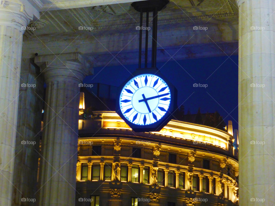 Clock in the city at night.
Central station of Milan,Italy