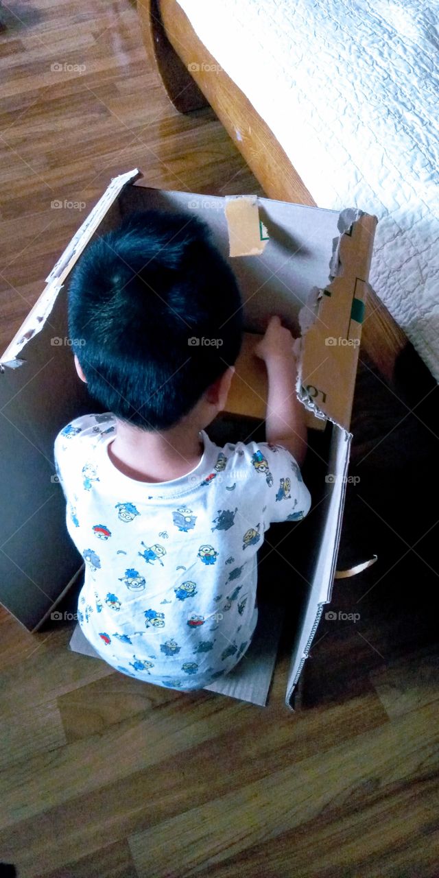 this little boy start building a table inside his room.