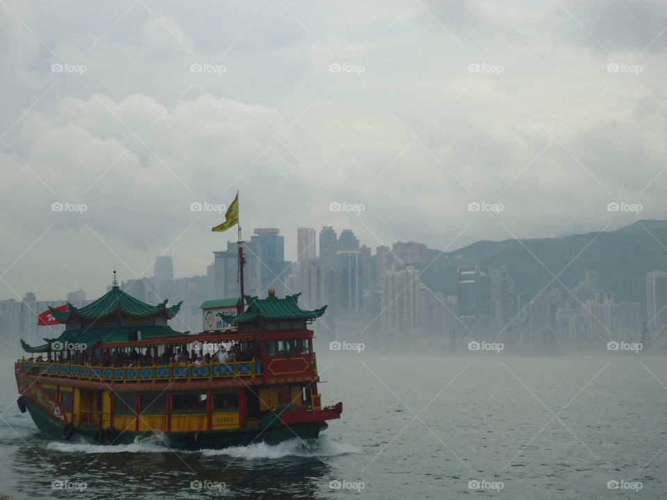 hongkong. a chinese boat cruising while we were on the avenue of the stars