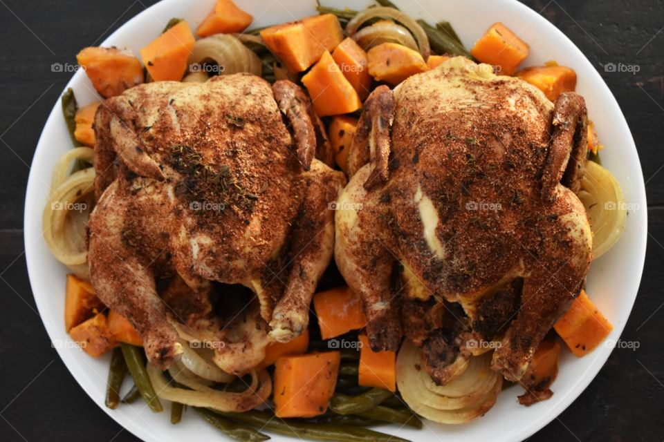 Spice-rubbed Cornish hens with sweet potatoes, green beans and onions