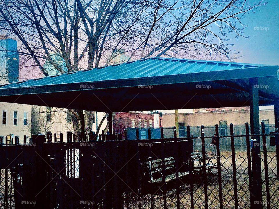 A closer up view of the unusual outside structure found on one late afternoon in Long Island City, Queens, NY that has elements of an Asian pagoda or temple with the wide triangular shaped rooftop. Autumn 2020. Hypnotic Productions