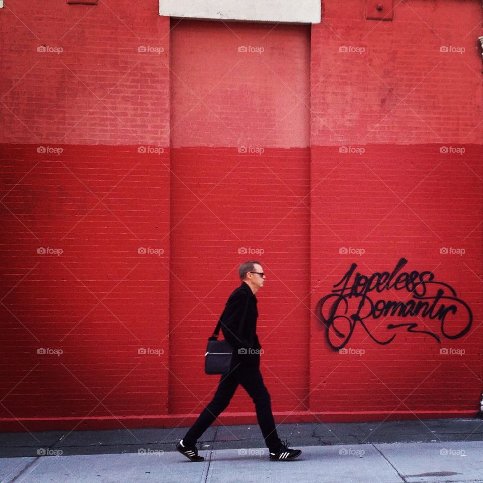 Man in front of a red wall