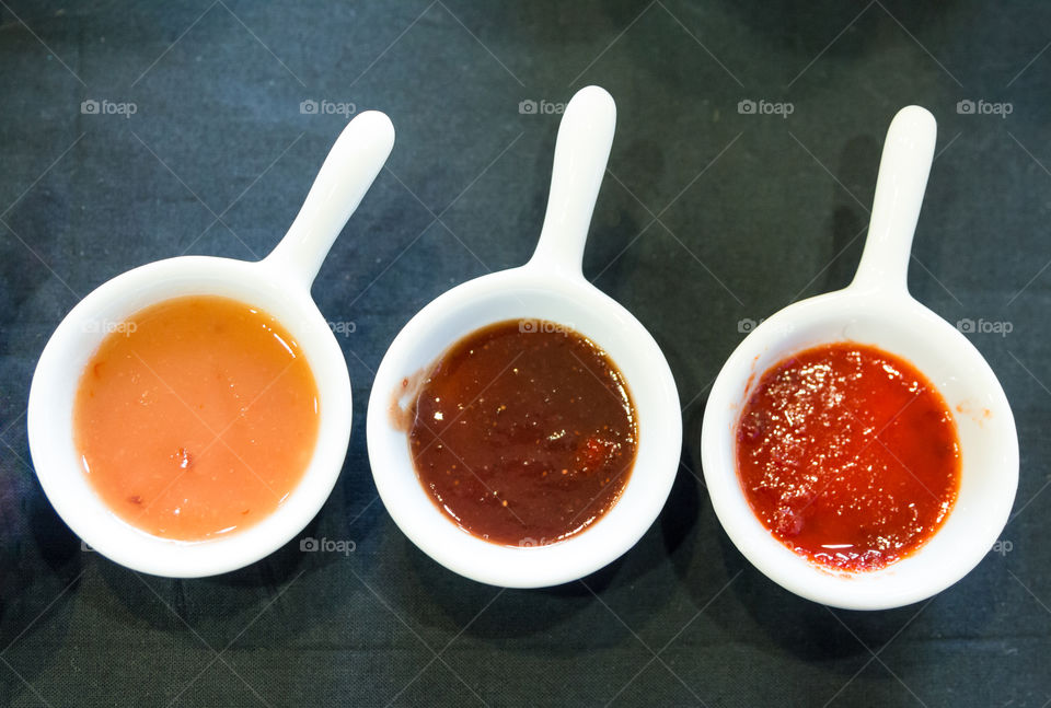 Variety Of Dip Sauces In White Bowls
