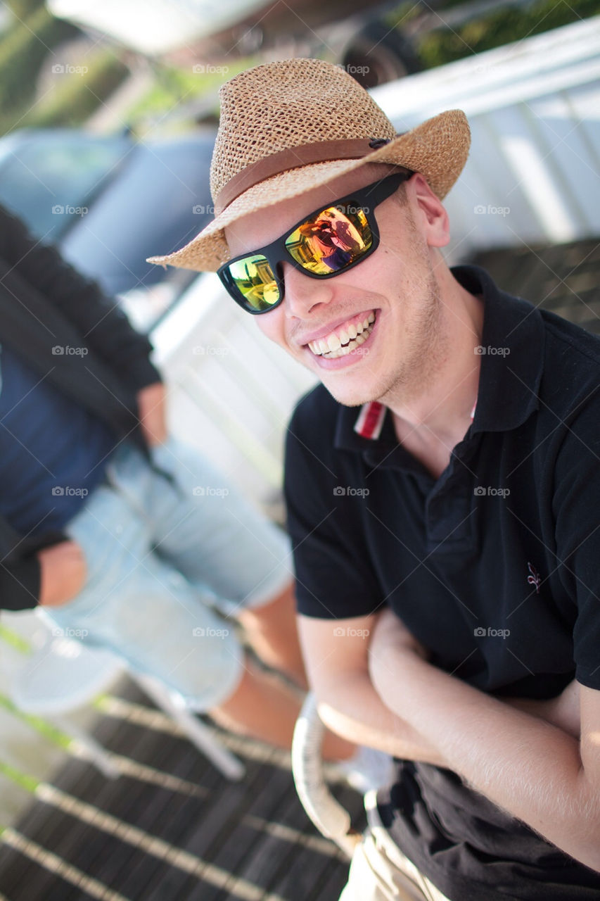 Happy laughing man in hat and sunglasses