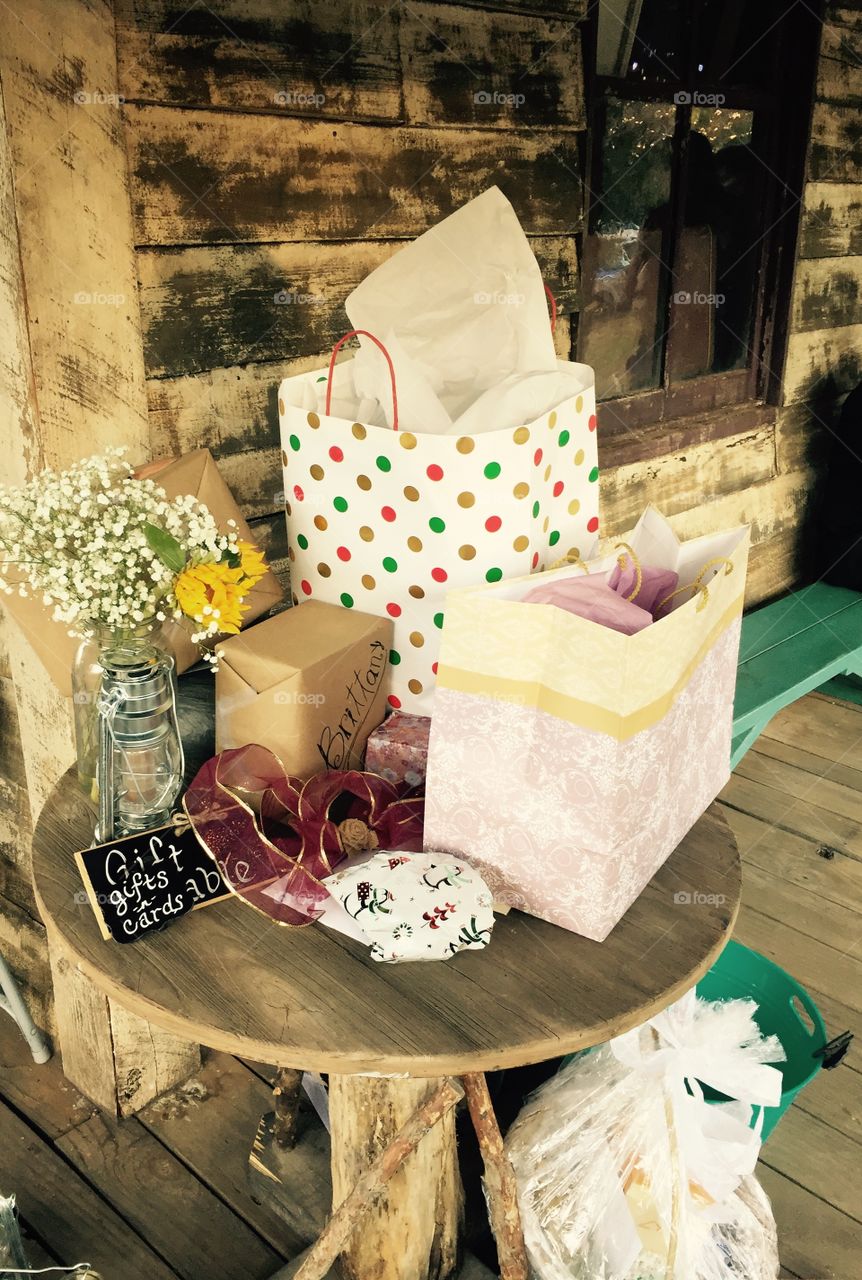 Wedding packages on display on an old table at an old building where you can see the old walls and old floor at this wedding venue.