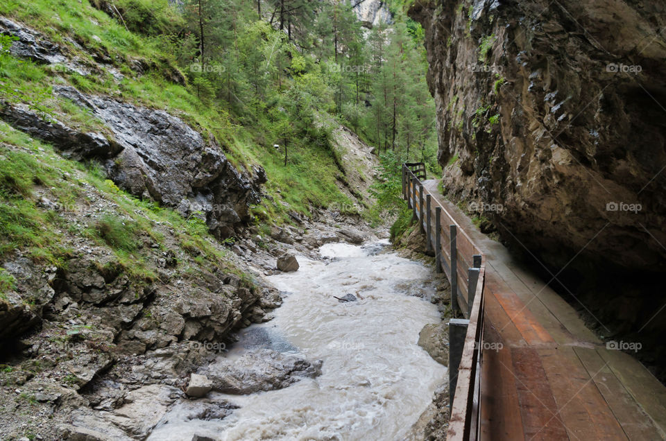 River flowing amidst rocks in forest.