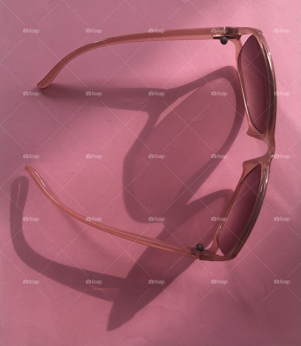Pink sunglasses playing with lights and shadows