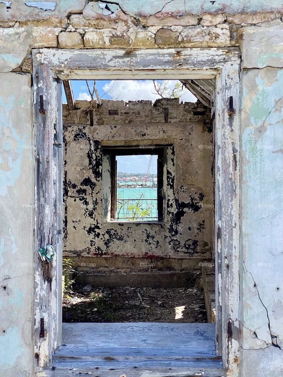 Looking through a door and a window in an old building