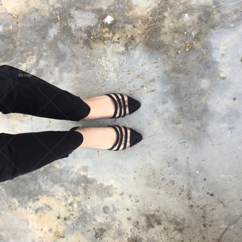 Woman wearing black pants and black high heel shoes in old town great for any use.