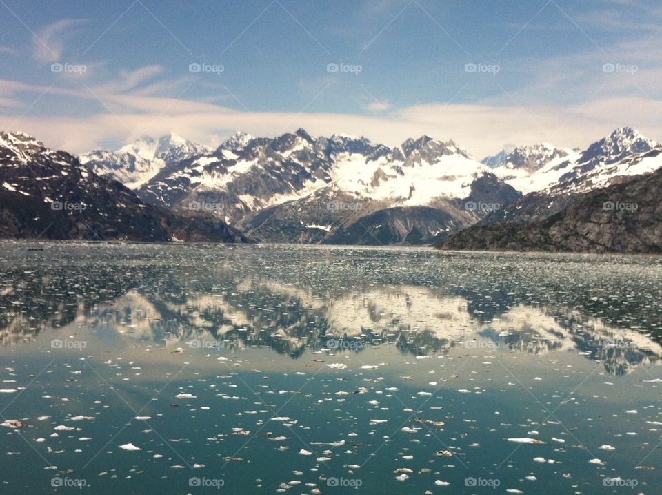 View of snowy mountain reflected in lake