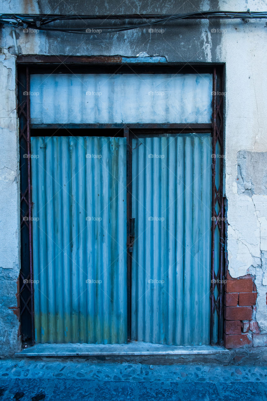 Old door in the city of Cefalu on Sicily.