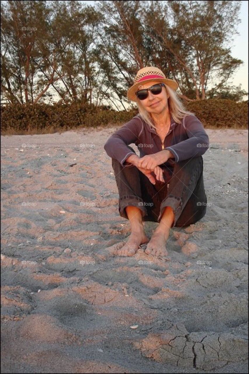 Pretty lady relaxing on the beach.