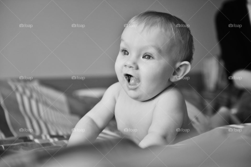 Cute baby lying on bed