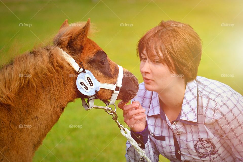 Trust. A foal and a girl 