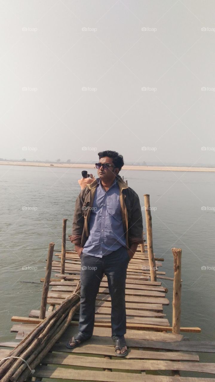 MAN, BRIDGE AND RIVER