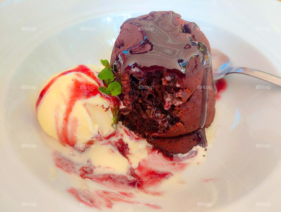 Chocolate souffle with raspberries and ice cream.  Elegance and delicious dessert