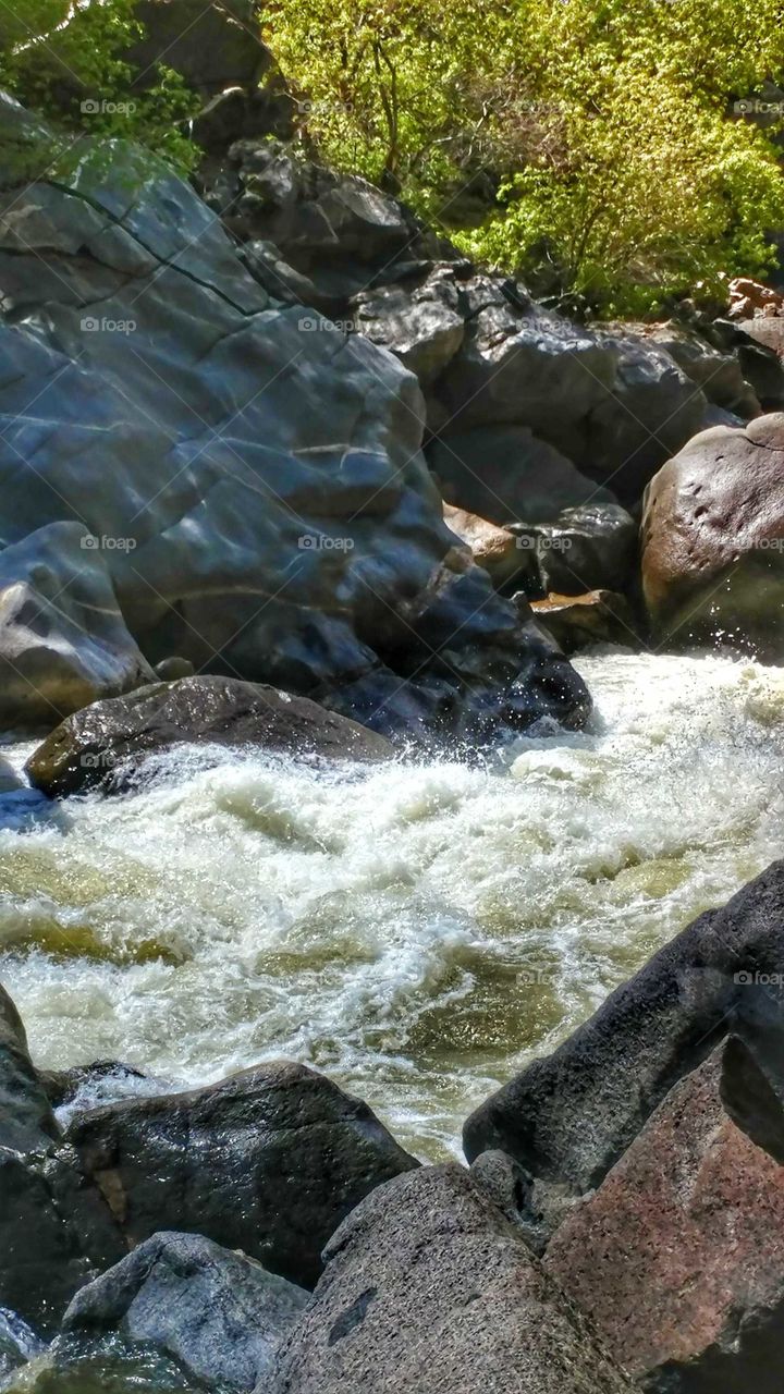 Giant boulders stand guard as white water rushes down the canyon.