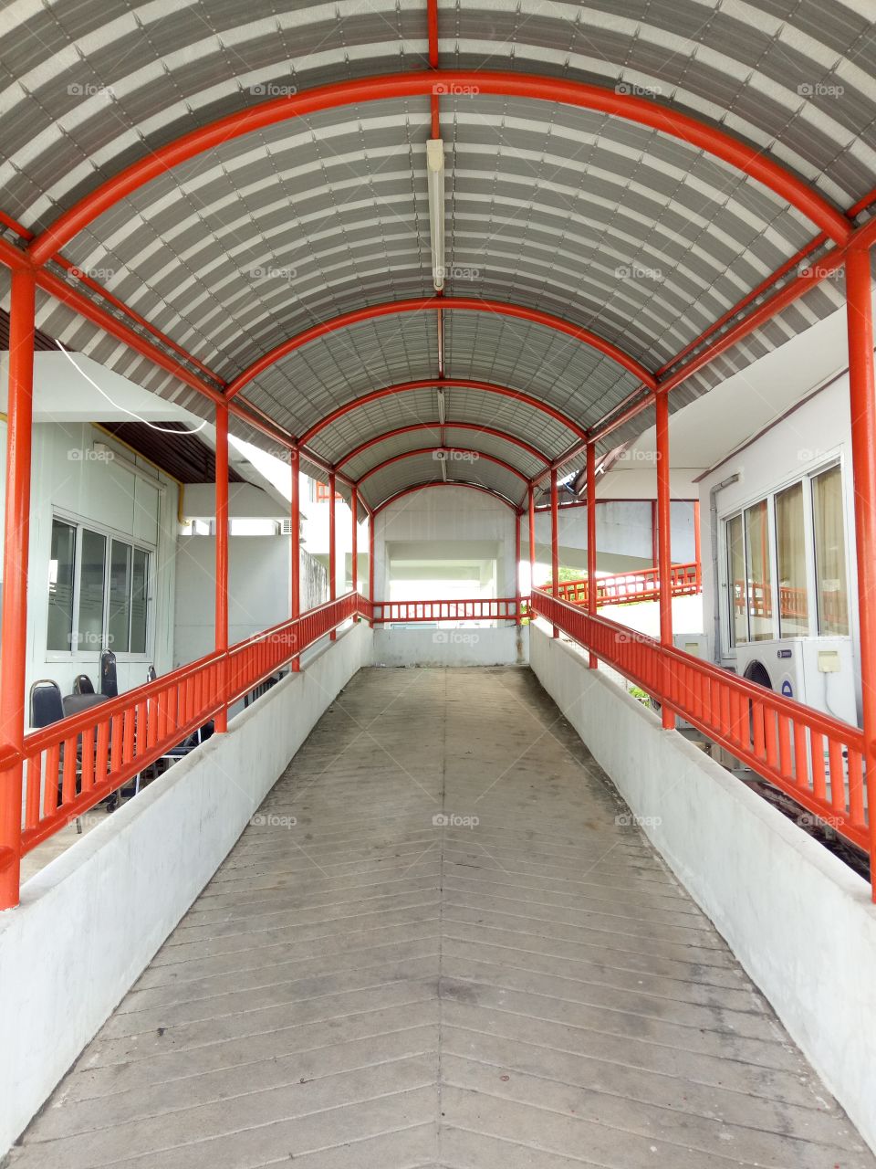 Slope path for wheelchairs with an orange rail.