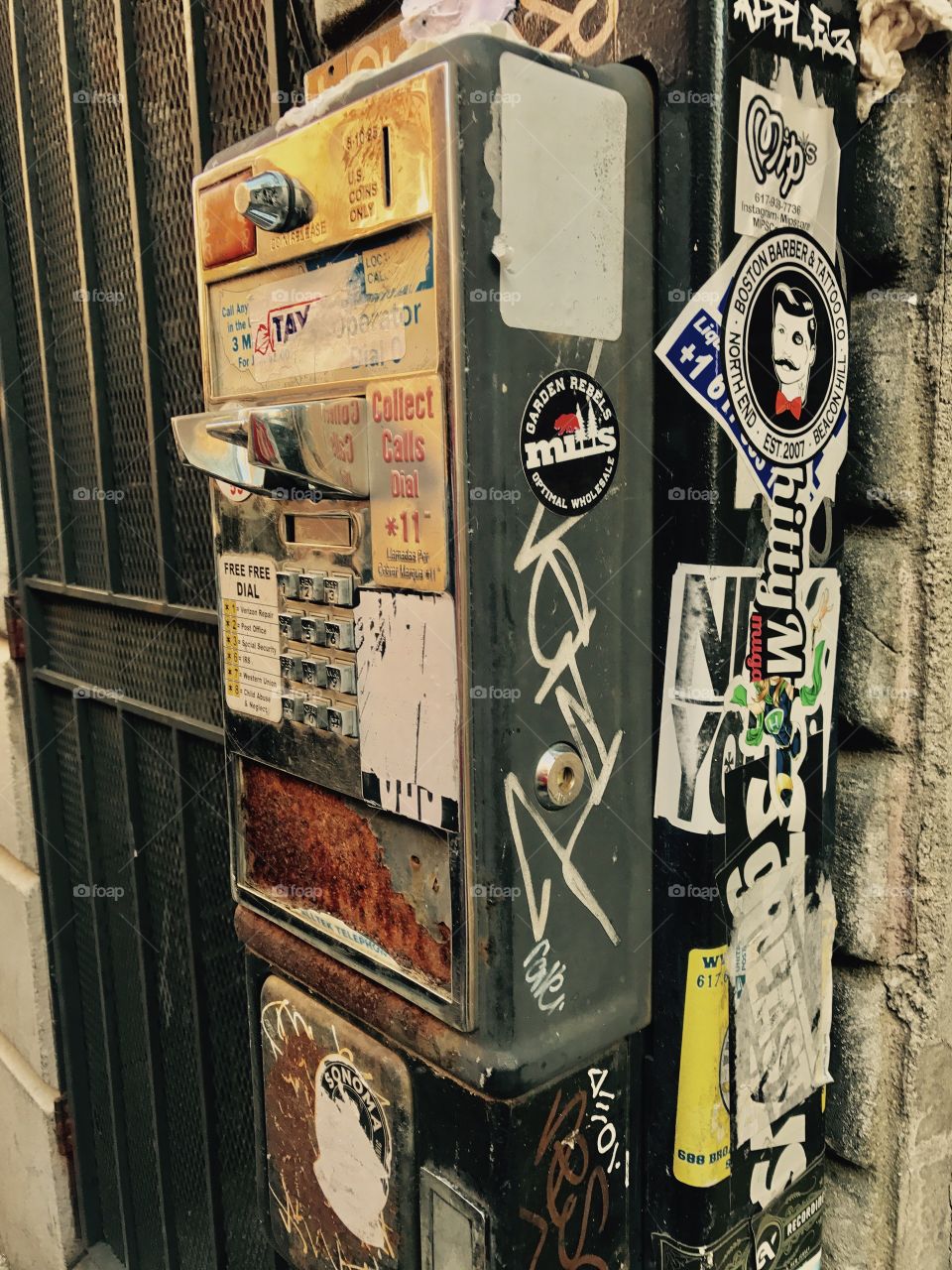 Old pay phone with graffiti 