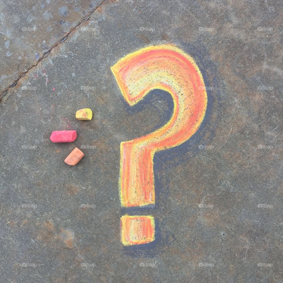 Question mark drawn in sidewalk chalk on cement