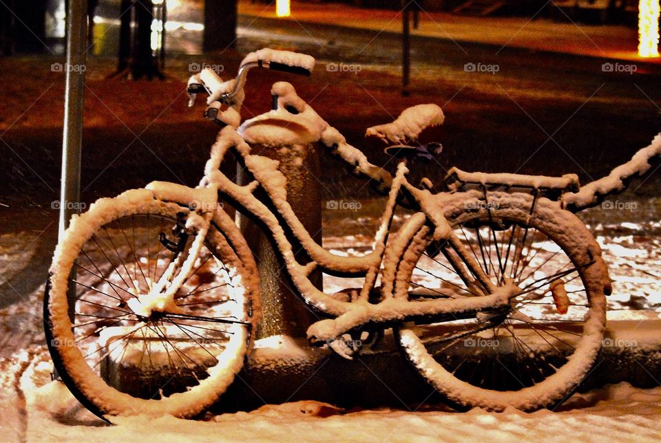 a snowy bike on a winter night