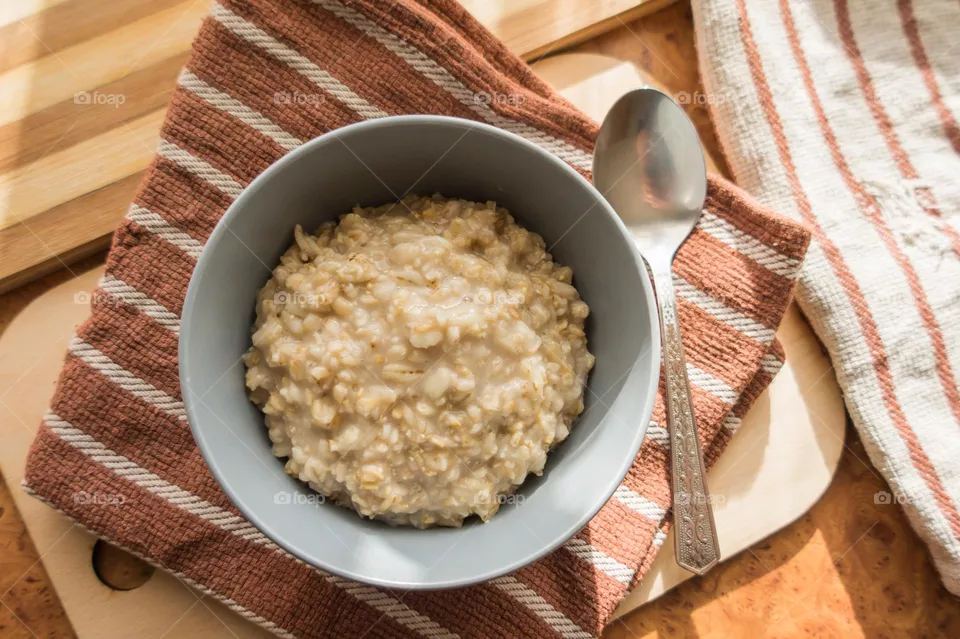 Cooked oatmeal in a deep gray plate.