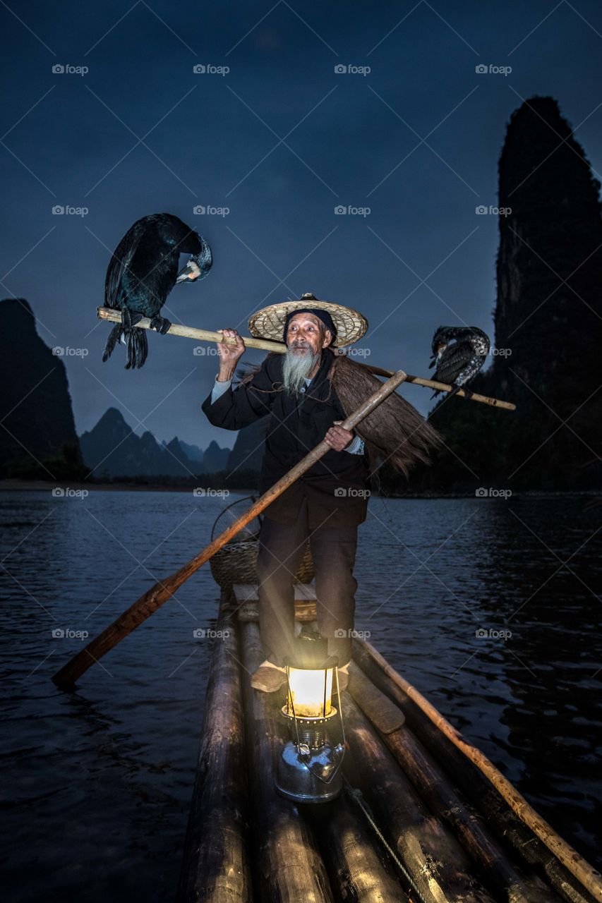 Cormorant fisherman with his birds
