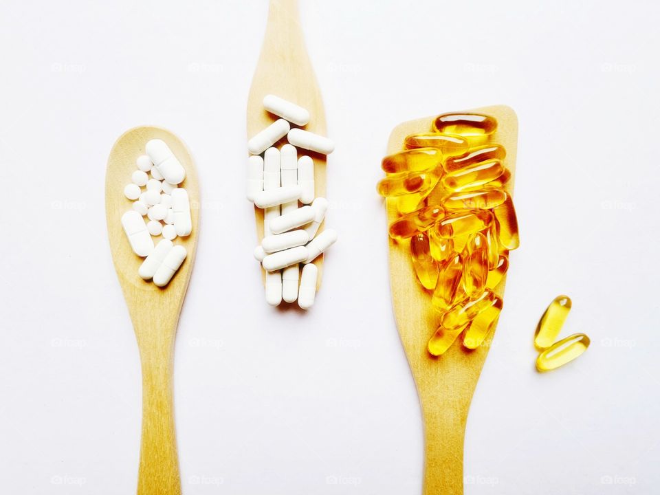 flat lay with wooden ladles containing food supplements