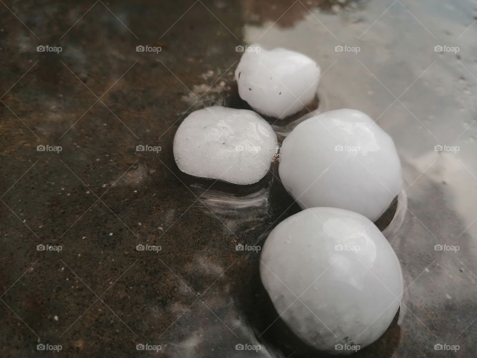 Large Hailstones or Hail Ice Balls on ground after hailstorm,hail are large in size,selective Focus and close-up after Heavy rain and storm.