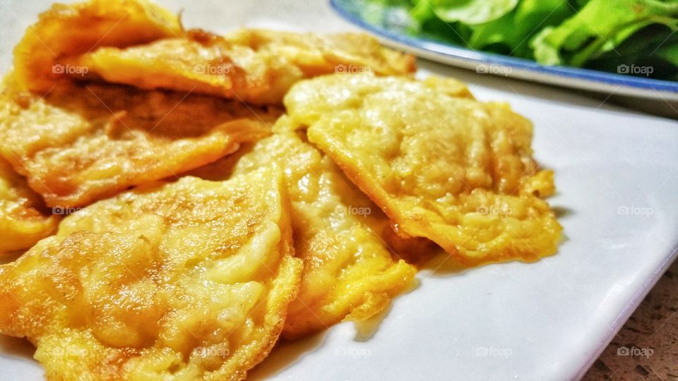 Fried egg prepared and presented in bite sized pieces.