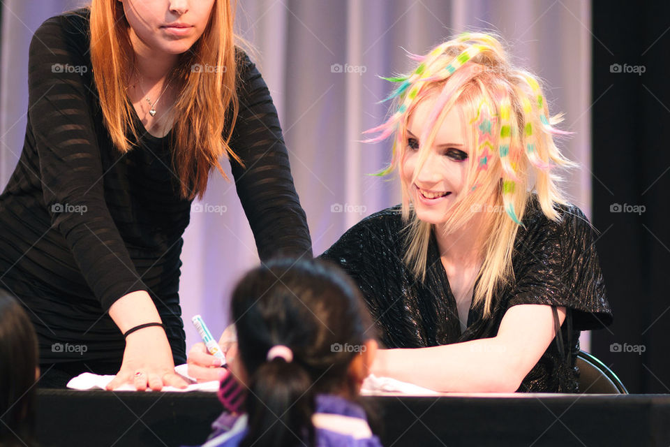 Swedish artist Yohio signing autographs for his fans after a concert