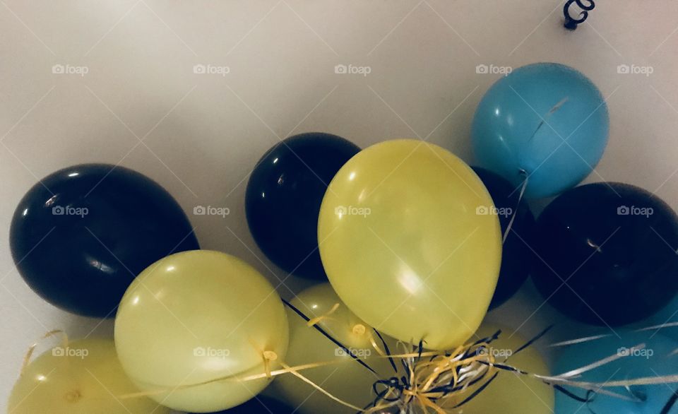 Colorful and big yellow black and blue balloons displayed for a birthday party, for a sweet 16 birthday. USA, America