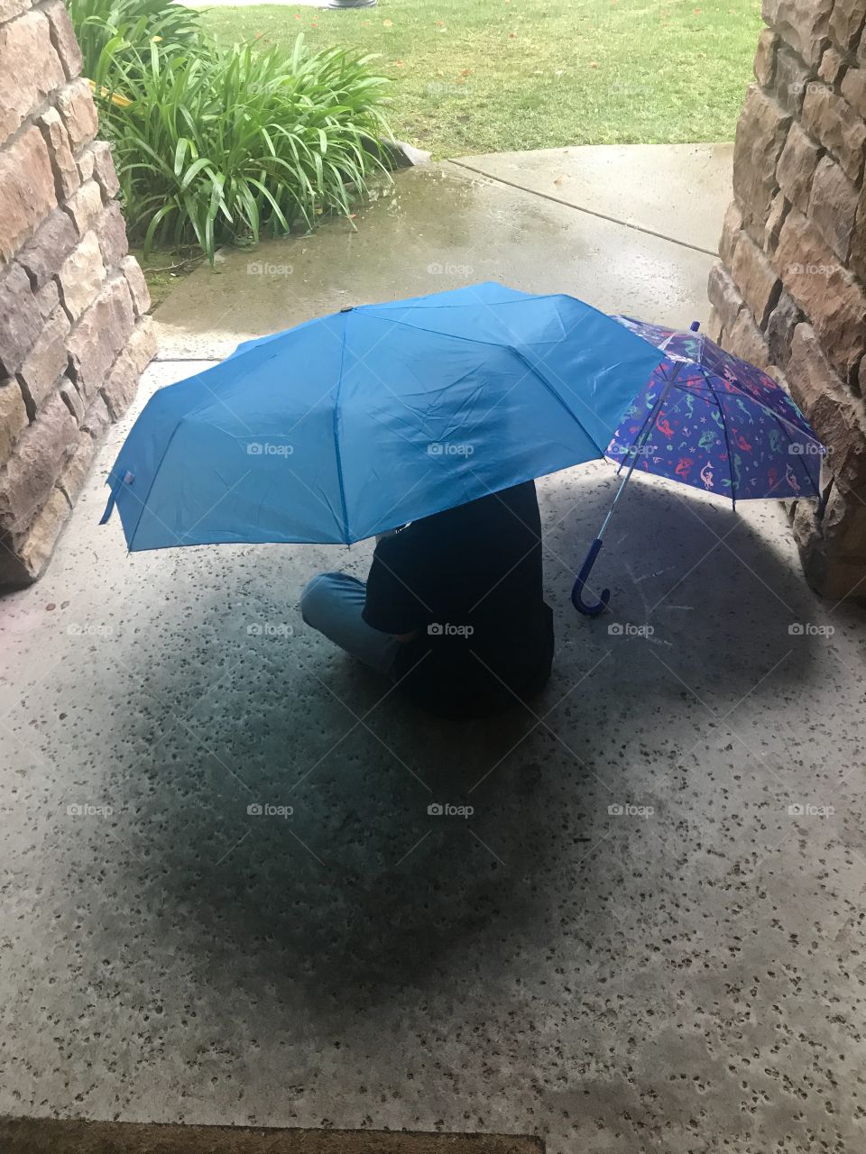 Keeping dry from the rain with a big umbrella 