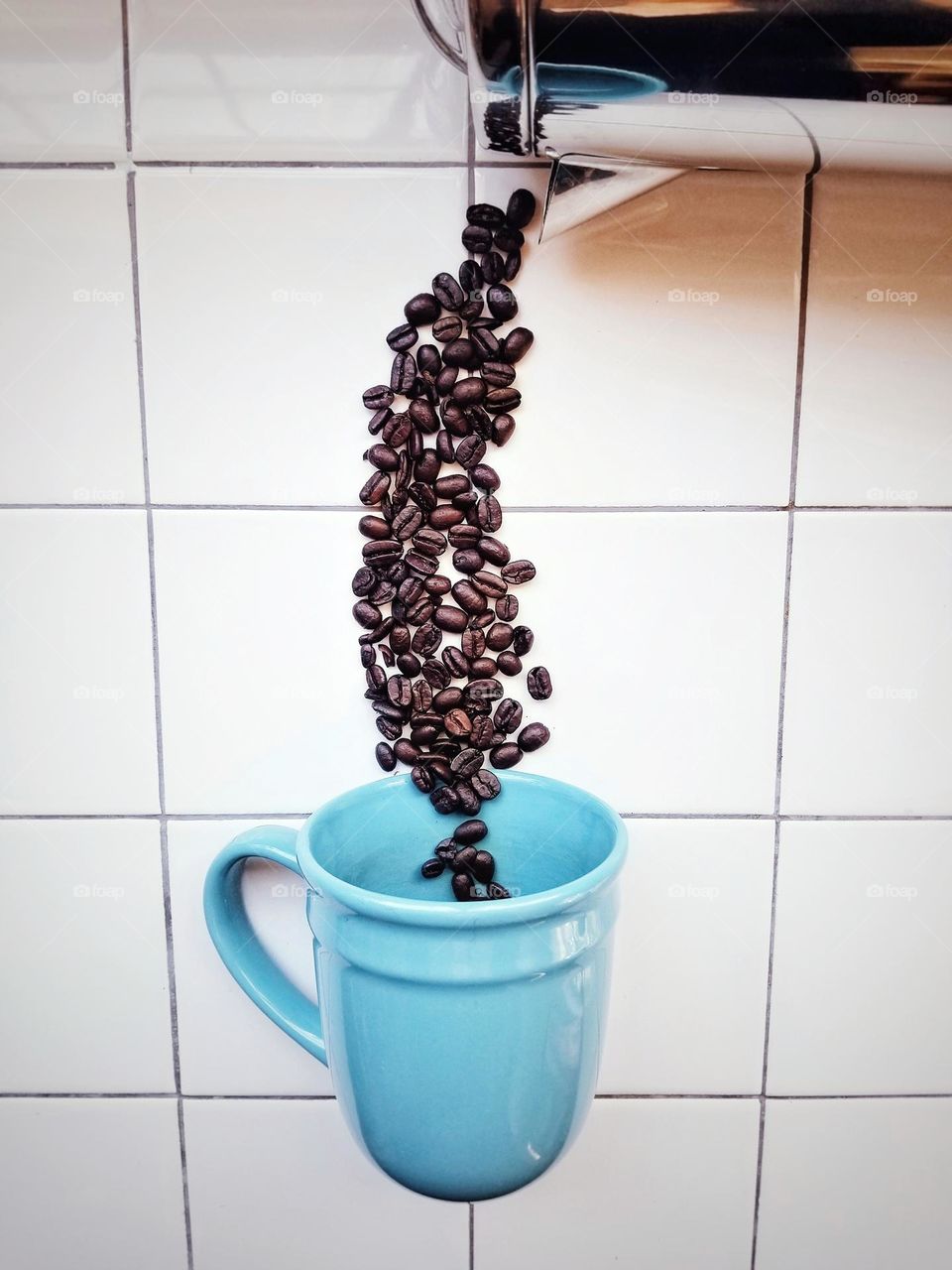 Pouring Coffee Beans from a Pot to a Mug