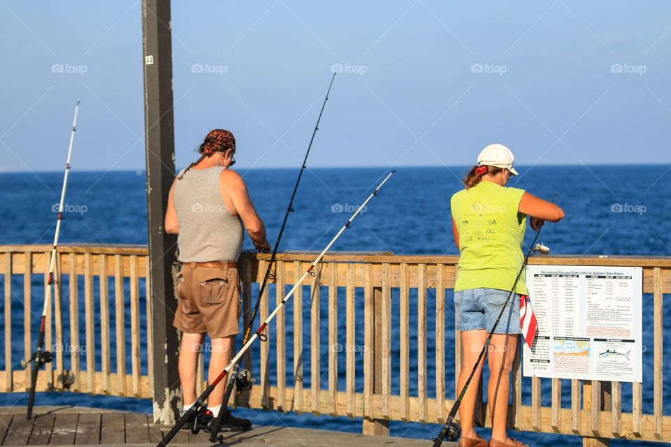 People fishing at the sea port