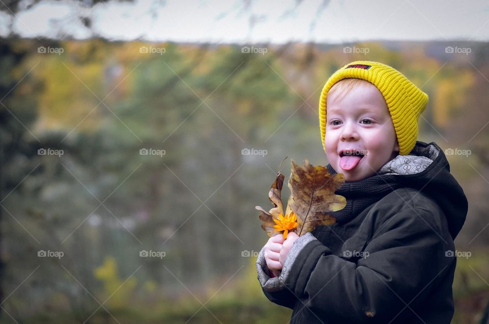 Boy with a yellow leaves.