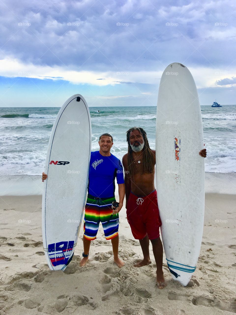 Two old school surfers on a South Florida beach.