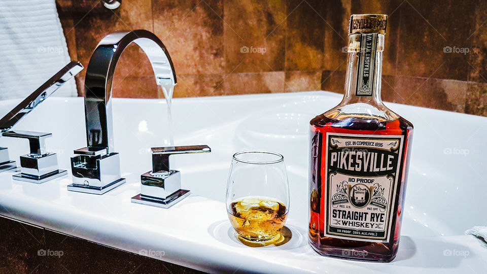 a glass of whiskey and the jacuzzi