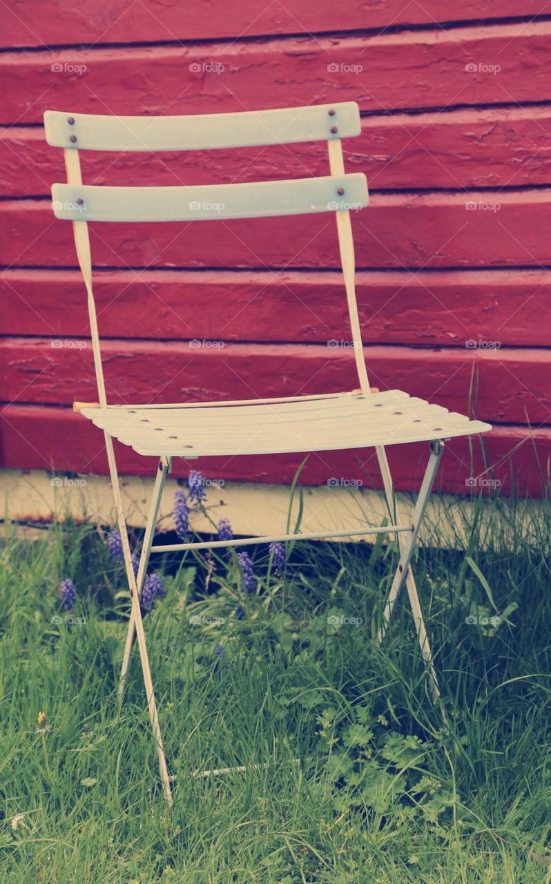 Red wall and vintage chair. Red wooden wall and white vintage chair