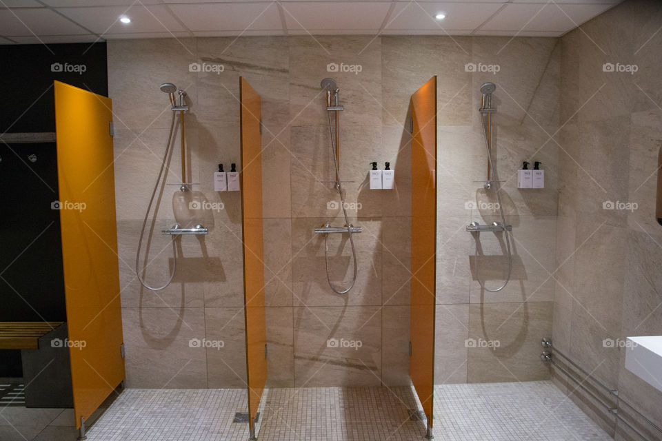 Showers at a pool area in a hotel.