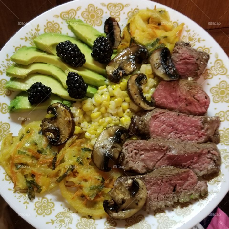 Juicy beef tenderloin and  baby bella mushroom slices, along with fresh, first-of-the-season corn, baked veggie nests of sweet onion, carrot and kale, and an antioxidant punch from sliced hass avocado and fresh blackberries.